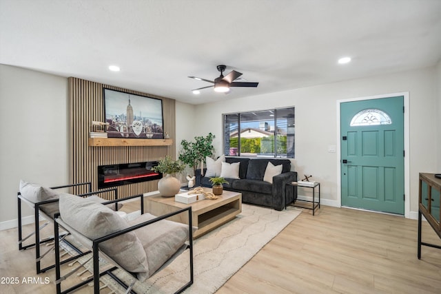 living room featuring ceiling fan and light wood-type flooring