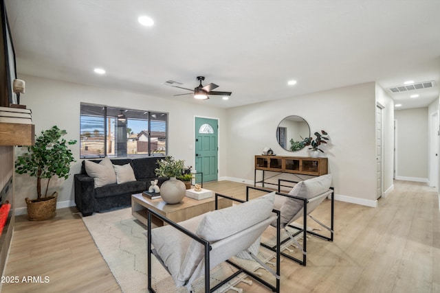 living room featuring ceiling fan and light hardwood / wood-style flooring