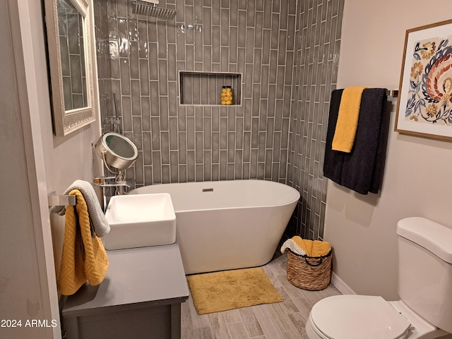 full bathroom featuring vanity, hardwood / wood-style flooring, toilet, and separate shower and tub