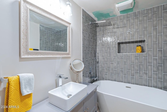 bathroom featuring tiled shower / bath and vanity