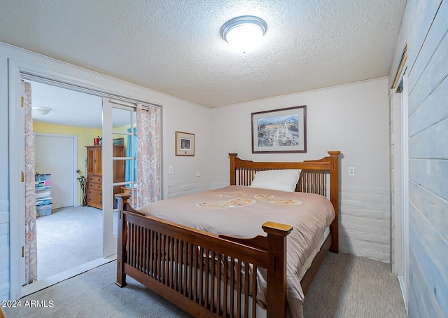 bedroom featuring carpet flooring and a textured ceiling