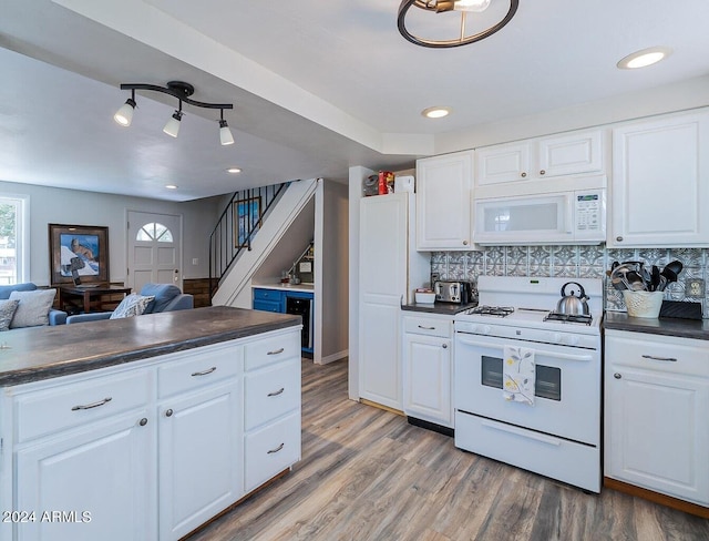 kitchen with light hardwood / wood-style floors, white cabinets, and white appliances