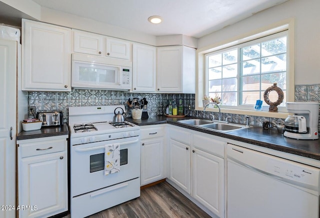 kitchen with decorative backsplash, white cabinets, dark hardwood / wood-style floors, sink, and white appliances