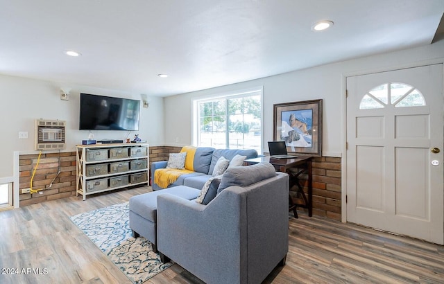 living room featuring wood-type flooring and heating unit