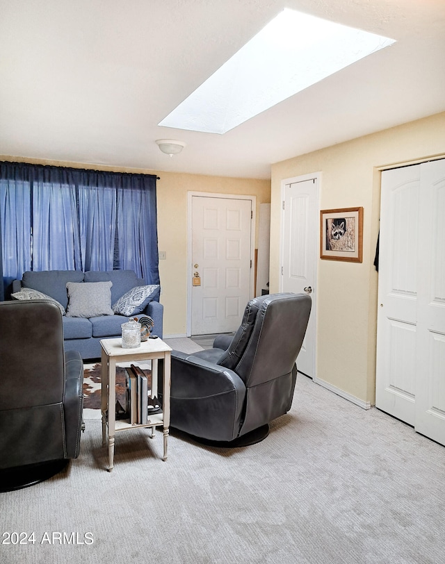 living room featuring a skylight and carpet floors