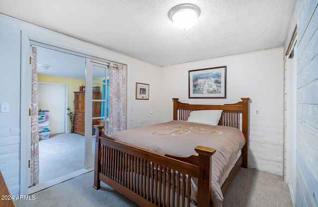 carpeted bedroom with a textured ceiling