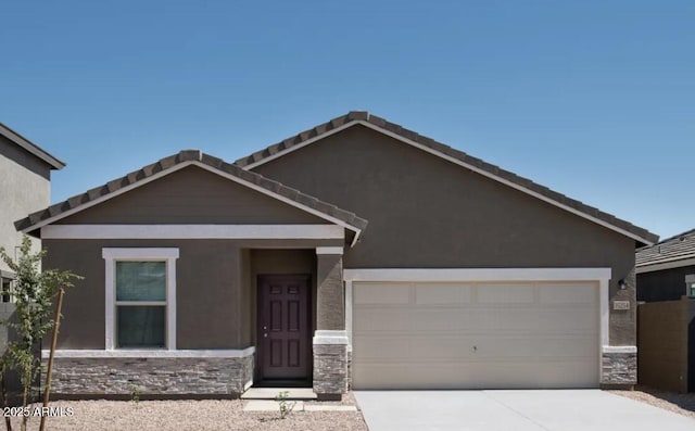 5818 W Sunrise Dr, Laveen, AZ 85339 - view of front of house with stone siding, a garage, concrete driveway, and stucco siding
