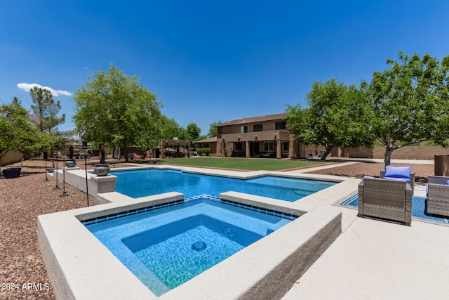 view of swimming pool with an in ground hot tub