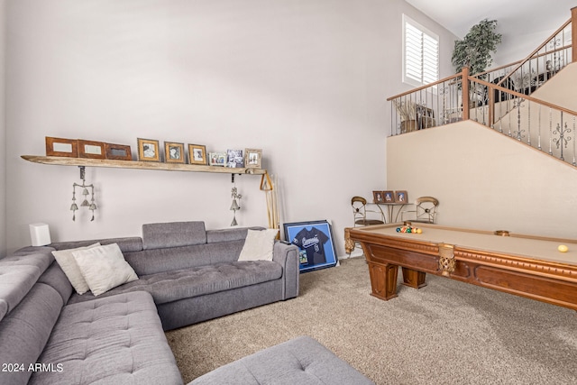 carpeted living room with a high ceiling and billiards