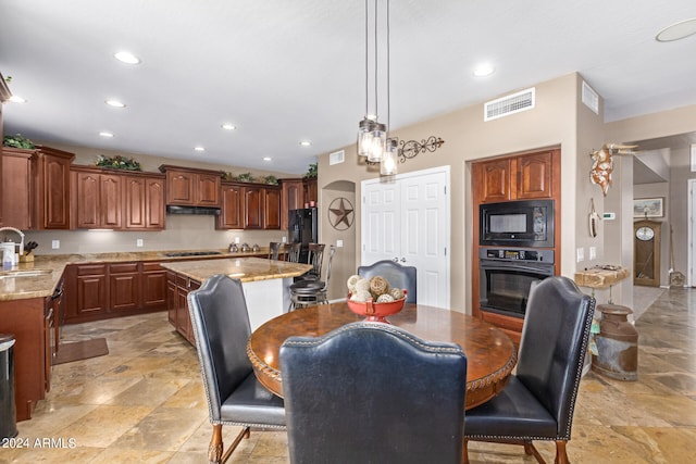 dining area featuring a fireplace and sink