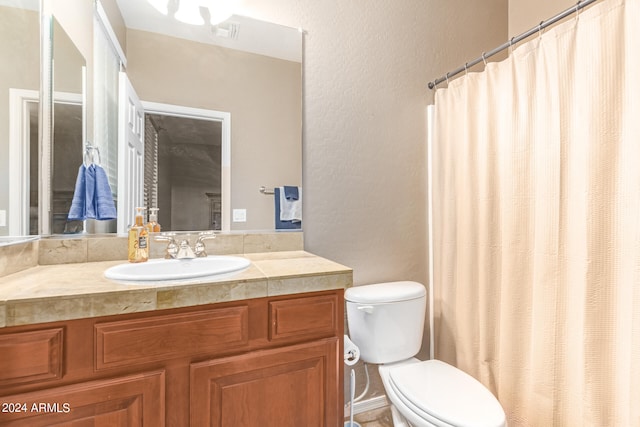 bathroom featuring toilet and vanity