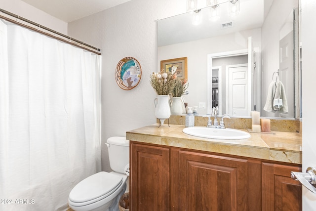 bathroom with toilet and vanity