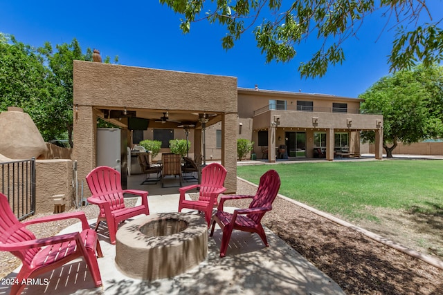 view of patio with ceiling fan, a fire pit, and a balcony