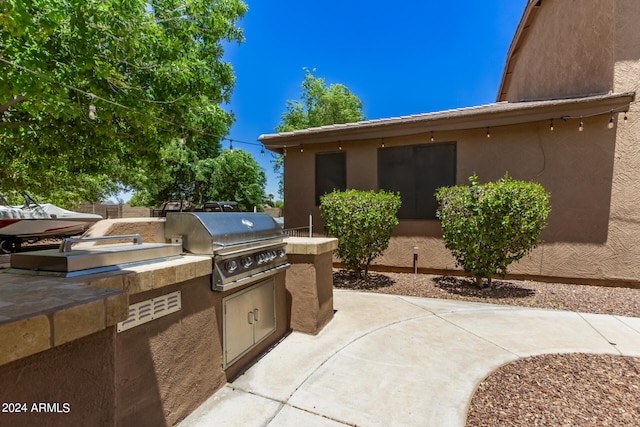 view of patio featuring a grill and an outdoor kitchen