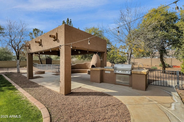 view of patio with a grill and an outdoor kitchen