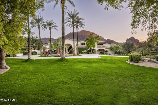 yard at dusk featuring a mountain view