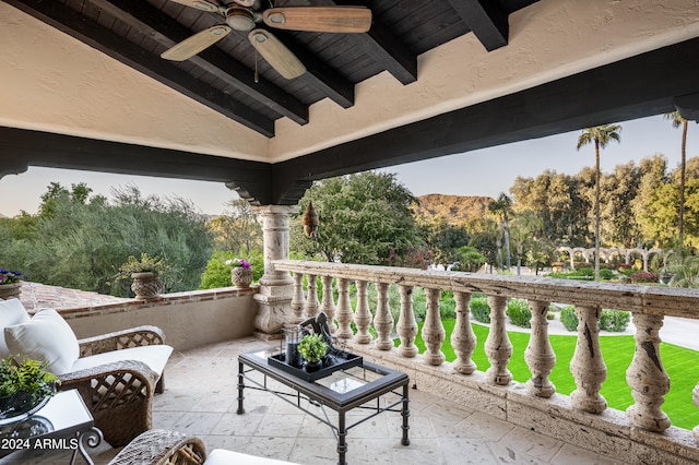 balcony featuring ceiling fan and a mountain view