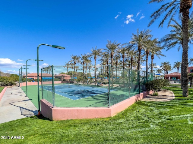 view of sport court with a lawn