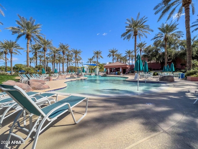 view of pool featuring pool water feature and a patio area