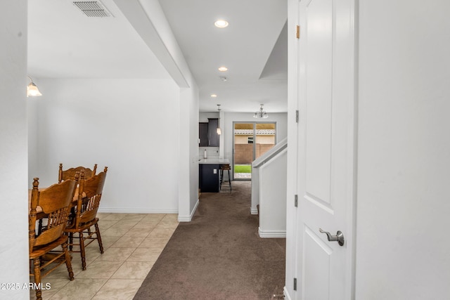 hall with light colored carpet, recessed lighting, light tile patterned floors, baseboards, and visible vents