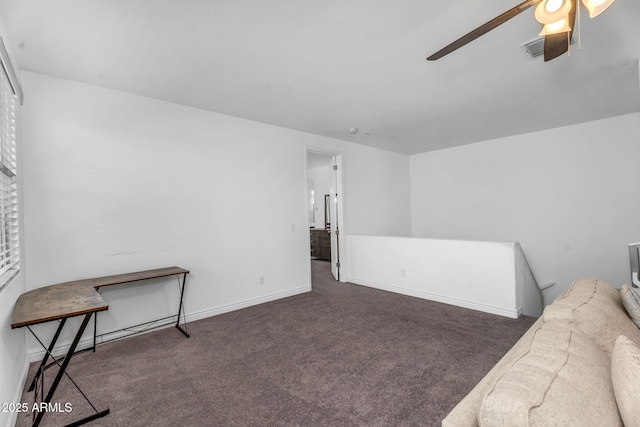 interior space with baseboards, visible vents, and ceiling fan