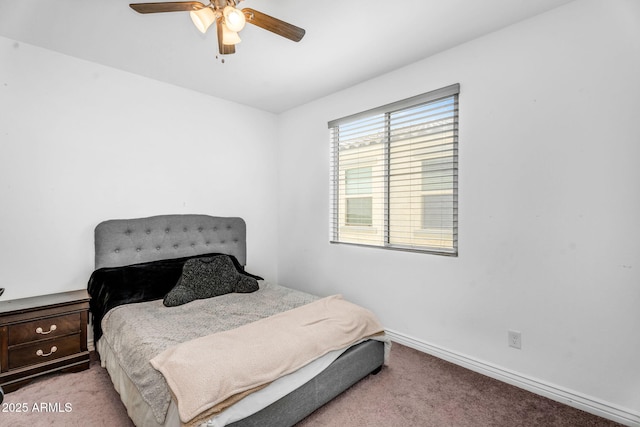 carpeted bedroom with baseboards and ceiling fan