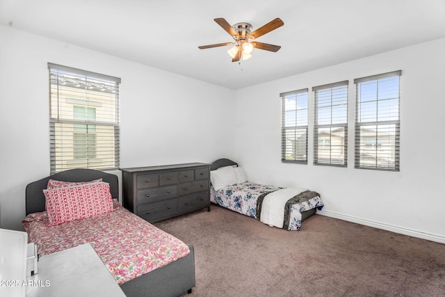 carpeted bedroom with baseboards, ceiling fan, and multiple windows