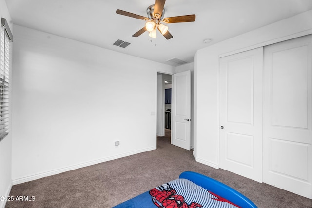 unfurnished bedroom featuring carpet floors, a closet, baseboards, and visible vents