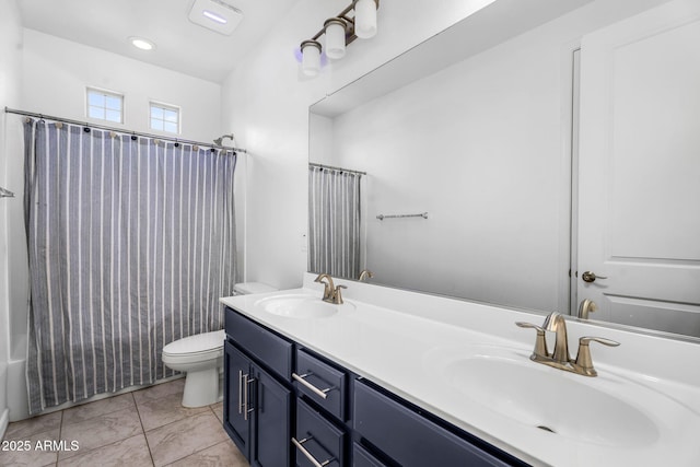 bathroom with double vanity, a sink, toilet, and shower / tub combo