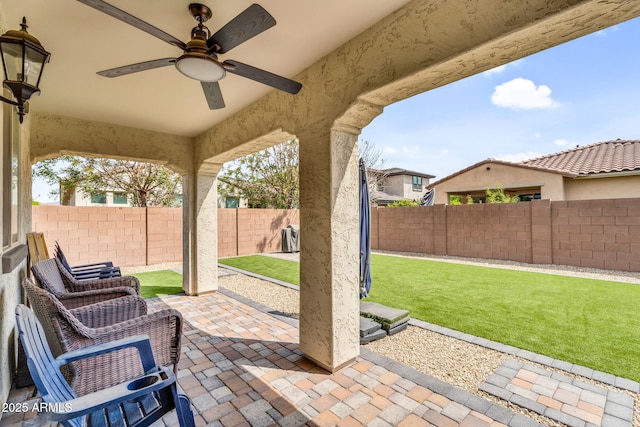 view of patio featuring ceiling fan and a fenced backyard