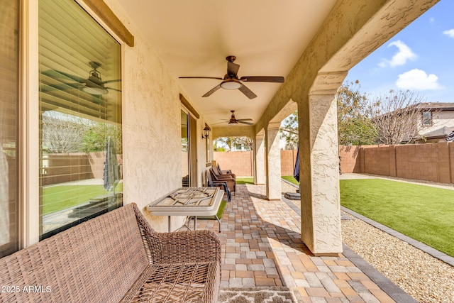 view of patio featuring ceiling fan and a fenced backyard