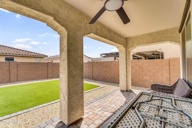 view of patio with a fenced backyard and ceiling fan
