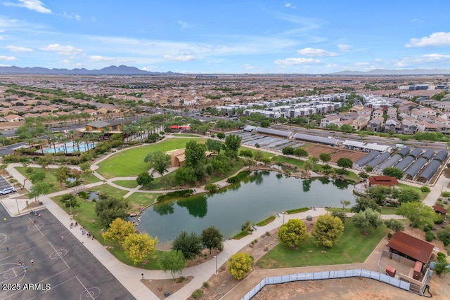 drone / aerial view with a residential view and a water and mountain view