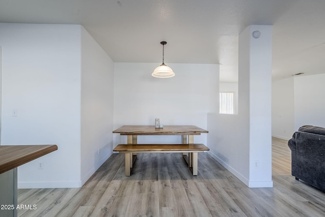 dining space with light hardwood / wood-style flooring