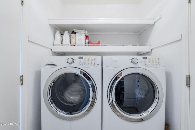 washroom featuring washer and clothes dryer