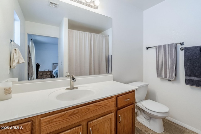 bathroom with vanity, tile patterned flooring, and toilet