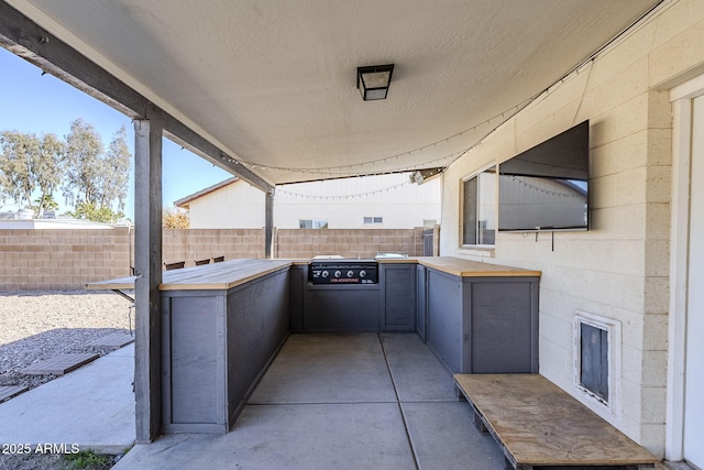 view of patio with area for grilling and an outdoor kitchen