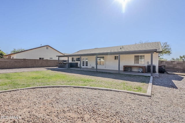 back of property featuring a yard and a patio area