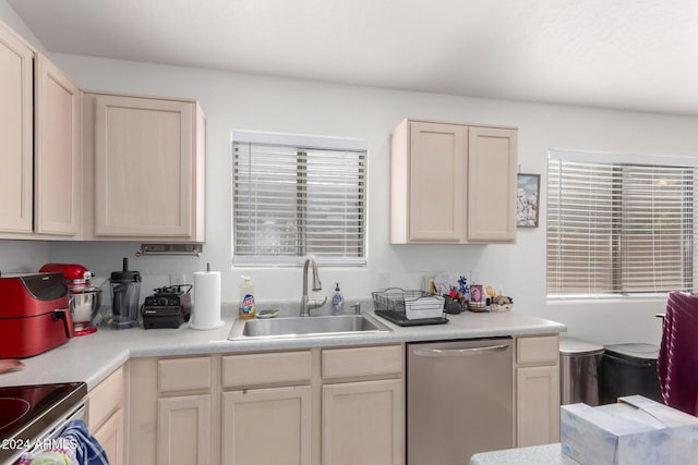 kitchen featuring dishwasher, light brown cabinets, and sink