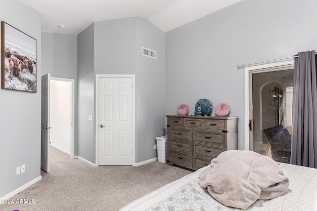 bedroom featuring light carpet and high vaulted ceiling