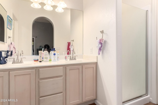 bathroom featuring vanity and an enclosed shower