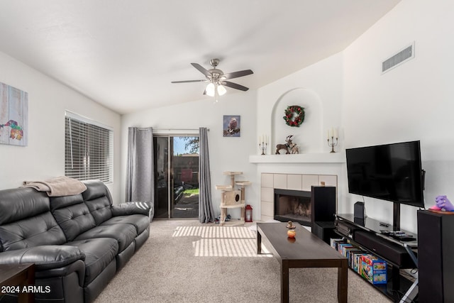 carpeted living room with ceiling fan, a fireplace, and lofted ceiling