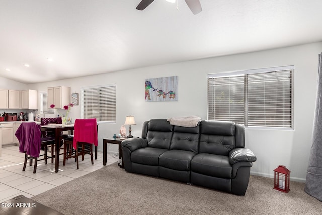 living room featuring ceiling fan, lofted ceiling, and light tile patterned flooring