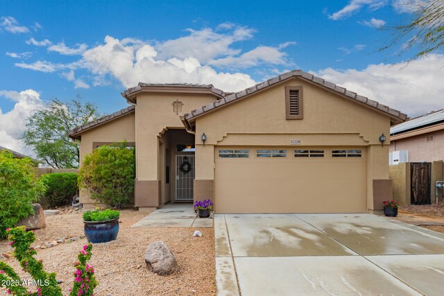 42328 N 46th Ln, Phoenix, AZ 85086 - view of front of house featuring driveway, stucco siding, a tile roof, and an attached garage