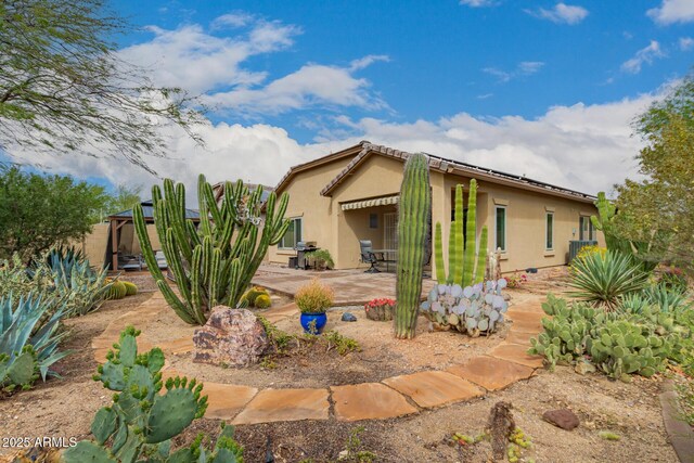 42328 N 46th Ln, Phoenix, AZ 85086 - exterior space with roof mounted solar panels, stucco siding, and a patio