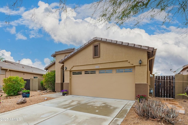 42328 N 46th Ln, Phoenix, AZ 85086 - view of front of property with concrete driveway, stucco siding, fence, an attached garage, and a gate