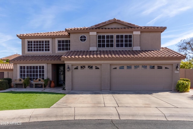 mediterranean / spanish-style house with a garage