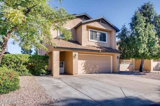 traditional-style house with an attached garage, driveway, a shingled roof, and stucco siding