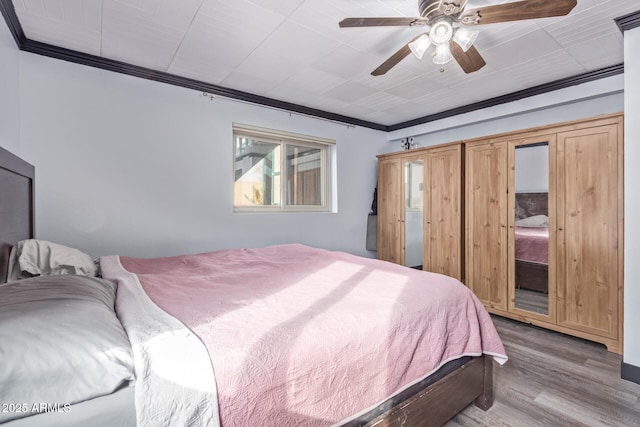 bedroom featuring access to exterior, ceiling fan, crown molding, and wood finished floors