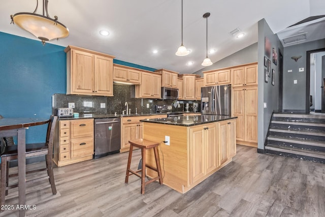 kitchen featuring tasteful backsplash, dark countertops, visible vents, light brown cabinetry, and appliances with stainless steel finishes